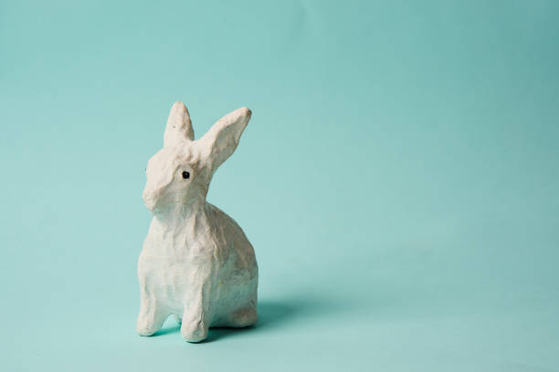 istock Festive white rabbit toy on a blue background with pastel colors Easter 2149843678