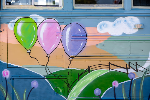 Mural detail on the exterior of party bus. Exterior of old school bus.