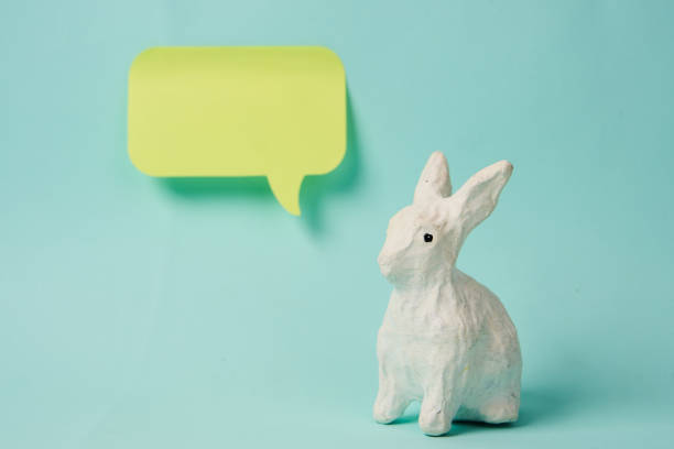 Easter bunny with a label for the inscription on a light background sticker Copy Space. High quality photo
