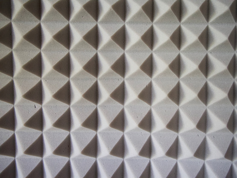 Grey acoustic foam rubber. Soundproof pyramids, full frame.