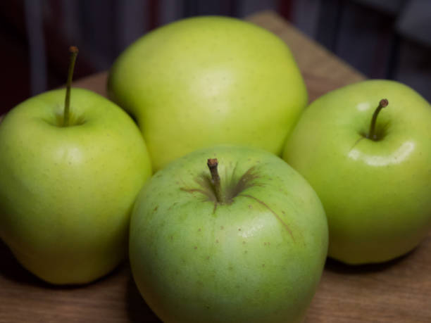 istock Four large apples, close-up. Fruit on a wooden surface. 2149844494