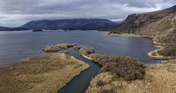 the south end of derwent water and the river derwent looking towards skiddaw with launch approaching jetty elevated aerial view
