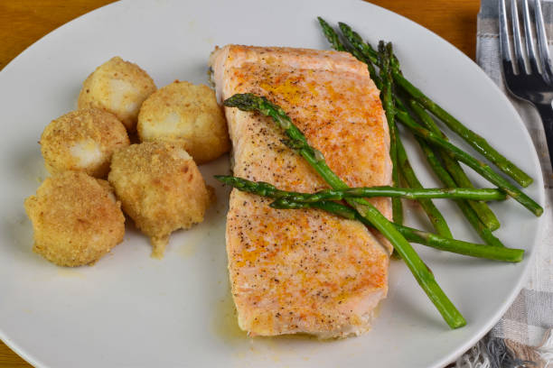 istock baked salmon served with scallops and asparagus 2149844867