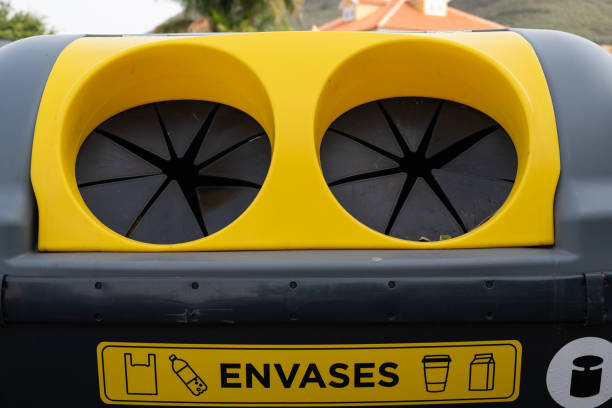 Yellow garbage container to put plastic containers inside to recycle them.