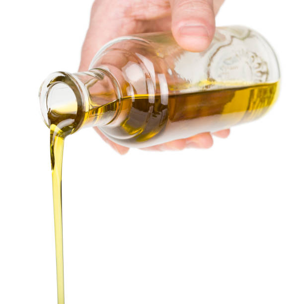 istock Oil pouring from a bottle. 2149846035