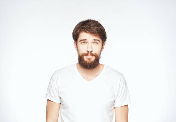 istock a man with a beard gestures with his hands on a light background Copy Space man 2149848802