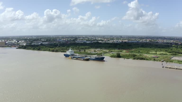 Wide orbiting aerial viewpoint of a tanker ship captured with drone mavic 2 pro. Over Suriname river in port of Paramaribo, capital of Suriname