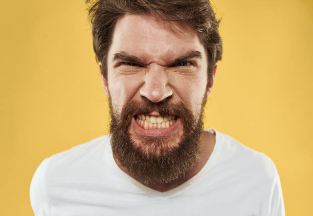 istock Bearded guy on a yellow isolated background gestures with his hands 2149849302