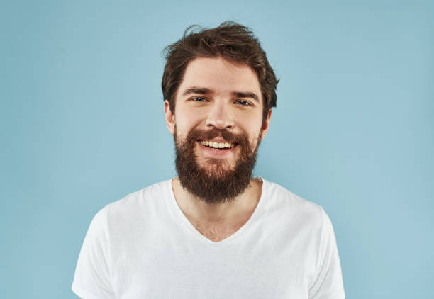 istock Handsome man with a beard on a blue background white t-shirt portrait 2149849419