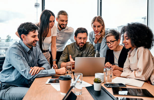 istock Brainstorm session. Corporate business team checking with interest project presentation on laptop from bearded male. 2149849632