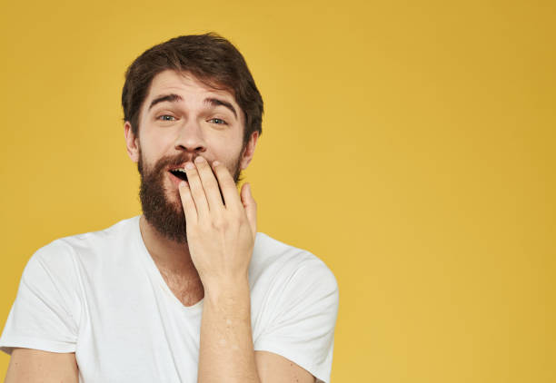istock Happy man with a beard gestures with his hands on a yellow background Copy Space 2149849644