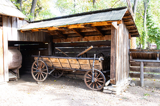 Antique wooden cart under a roof in the countryside