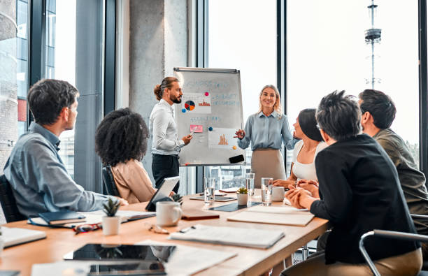 istock Business conference. Two employees present their project to the team. 2149849894