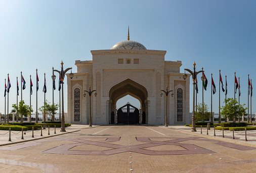 A picture of the farthest Qasr Al Watan gateway sided with multiple United Arab Emirates flags.