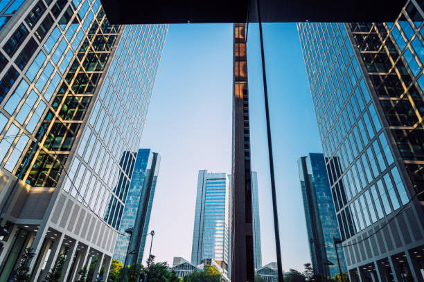 A dynamic image showcasing modern skyscrapers with reflective glass facades in a bustling commercial district, highlighting the blend of architecture and urbanism.