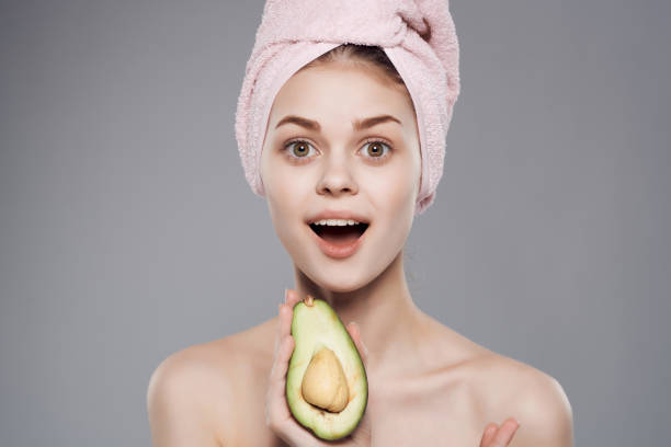 istock pretty woman bare shoulders with fruit exotic in hand cropped view 2149850774