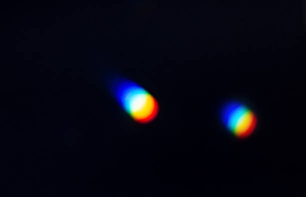 Rainbow reflective colorful sunlight on textured surface of wall. Dispersion and refraction of light.