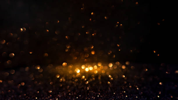 istock Warm golden bokeh lights illuminate a dark backdrop, creating an abstract pattern of soft glowing orbs ideal for backgrounds. Blurred shine bokeh for overlay effect. 2149851014