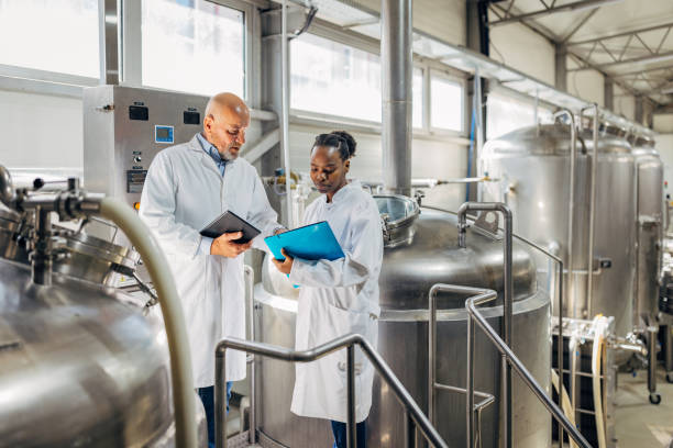 istock A beer technologist uses a digital tablet while explaining to a colleague about the operation of a brewery's beer production machine 2149853516