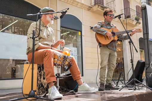 Two street musicians play in the center of town
