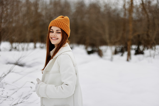 woman in winter clothes in a hat fun winter landscape winter holidays. High quality photo