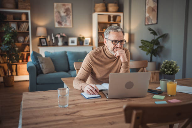 istock Middle aged man working from home office on laptop 2149855561