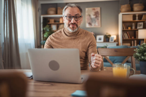 istock Middle aged man working from home office on laptop 2149855584