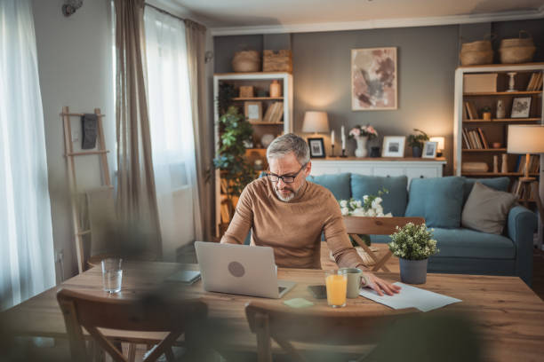 istock Middle aged man working from home office on laptop 2149855598