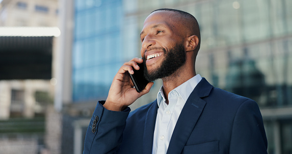 Happy, businessman and city with phone call for conversation, communication or chat outside building. Outdoor, young man or employee with smile on mobile smartphone for friendly business discussion