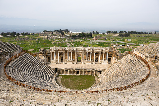 Wide-angle shot of Hierapolis Amphitheater with surrounding ruins and landscape in Turkey.