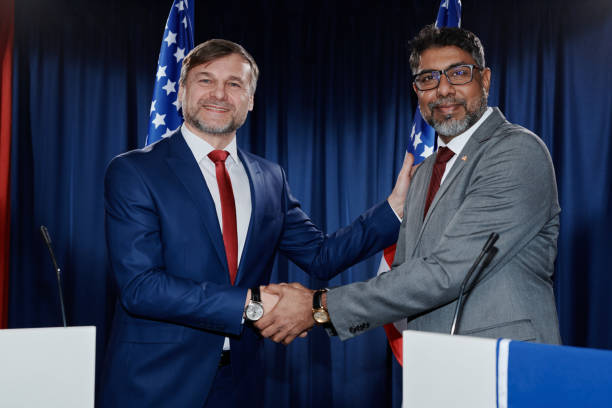 Men shaking hands in front of camera