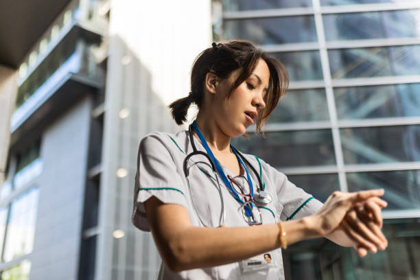 istock Young Nurse Woman in Uniform Checking the Time 2149857873