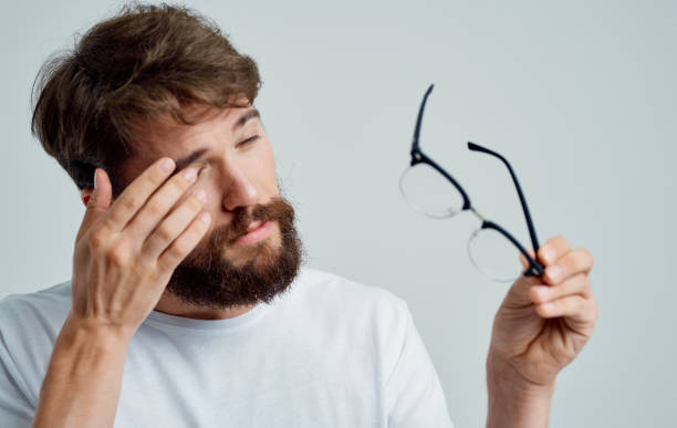 istock man with glasses in hand on a gray background vision problems eye pain diopter 2149857886
