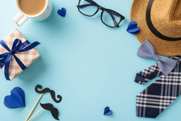 istock A thoughtful Father's Day gift setup with a bow tie, hat, coffee, and glasses, perfect for celebrating dad's special day 2149858784