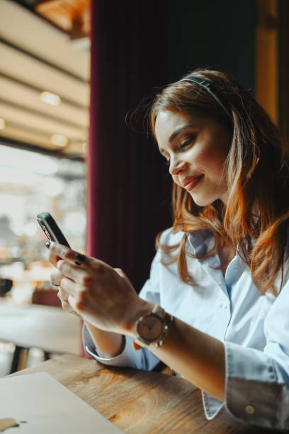 istock Female Watching Videos On Smartphone While Wearing Headphones 2149858932