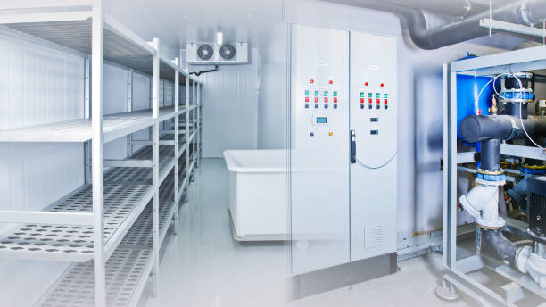istock Refrigeration chamber for food storage. Empty freezer. Industrial refrigerator. Freezer with metal shelving. Shield for controlling the freezer. Cabinet for cold management. Engine in the fridge 2149859150