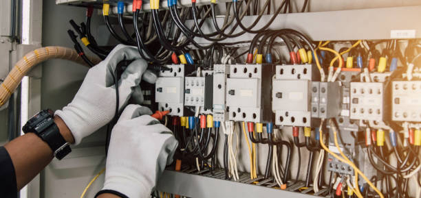 istock Electrician engineer tests electrical installations and wires on relay protection system. 2149859205