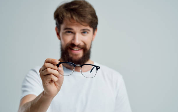 istock a man with glasses in his hand vision problems eye pain myopia hyperopia lenses 2149860157