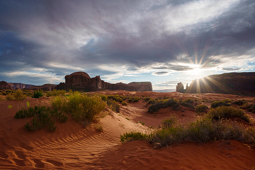 East and West Mittens and Merrick Butte in Monument Valley Tribal Park Utah Under a Dramatic Sunset Sky in Late Springtime
