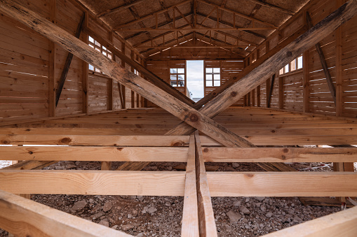 Traditional king post roof truss with open tie beams, rafters, top and bottom chords, king post, struts and purlins.