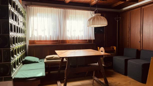 istock Wooden room with tiled stove, bench and table 2149862204