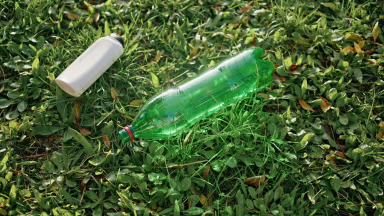 Plastic trash lying grass symbolize environmental pollution. PET waste on nature