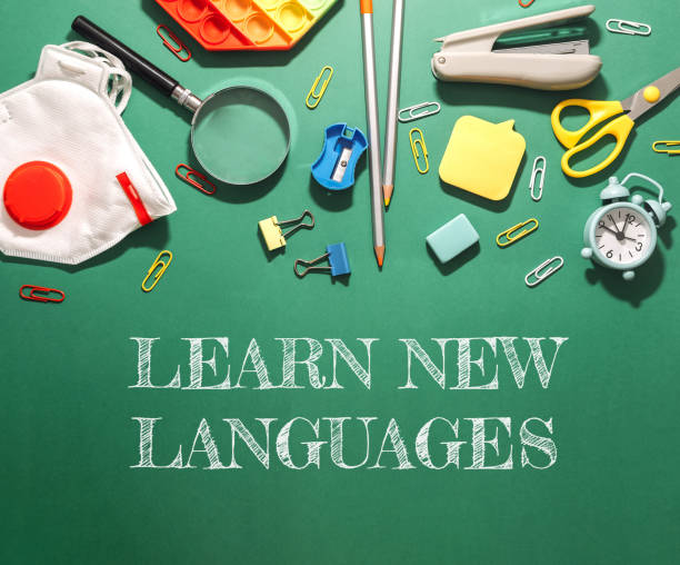 A green background with a white box that says learn new languages A green background with a white box that says learn new languages. There are many different colored items on the background, including scissors, a magnifying glass, and a clock opportunity dictionary definition stock pictures, royalty-free photos & images