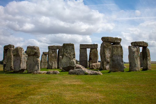 Stonehenge was built in six stages between 3000 and 1520 BCE. However the site was first used for ceremonial purposes beginning about 8000–7000 BCE. It consists of an outer ring of vertical sarsen standing stones, each around 13 feet high, seven feet wide, and weighing around 25 tons, topped by connecting horizontal lintel stones.