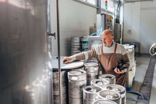 istock Male brewer in apron using digital tablet in industrial beer brewery 2149863856
