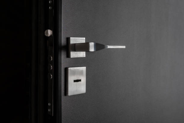 istock Modern black door with a metal handle and lock. 2149863889