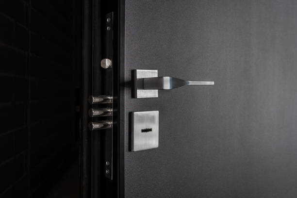 istock Modern black door with a metal handle and lock. 2149863893
