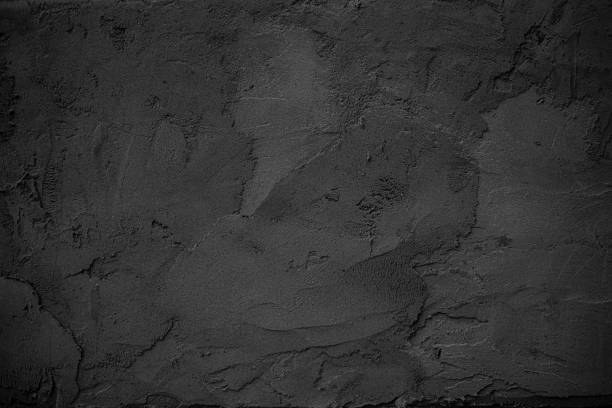 Dark Gray Textured Concrete Wall Background in Dim Lighting
