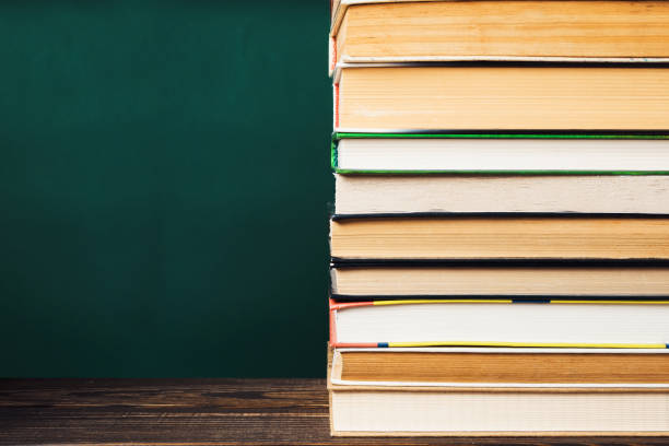 istock A stack of books on a table with a green background 2149864912