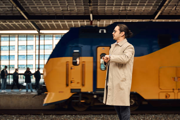 business man is looking watch in train station